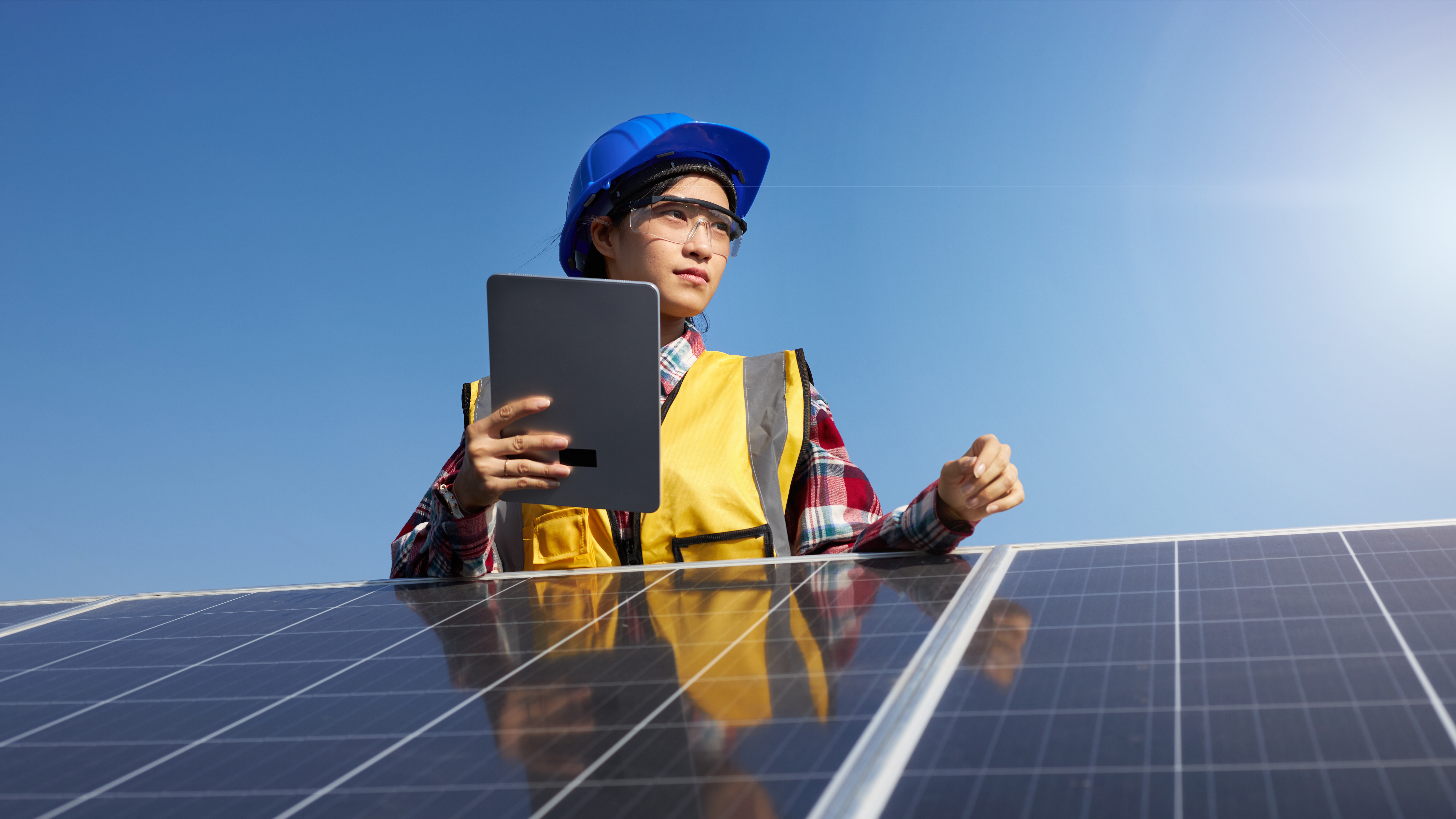 hard hat outside Employers Financial Support for Employers Lodging a claim young woman overseeing solar panels while holding a device clothing human face outdoor person sky solar solar cell solar energy solar panel solar power