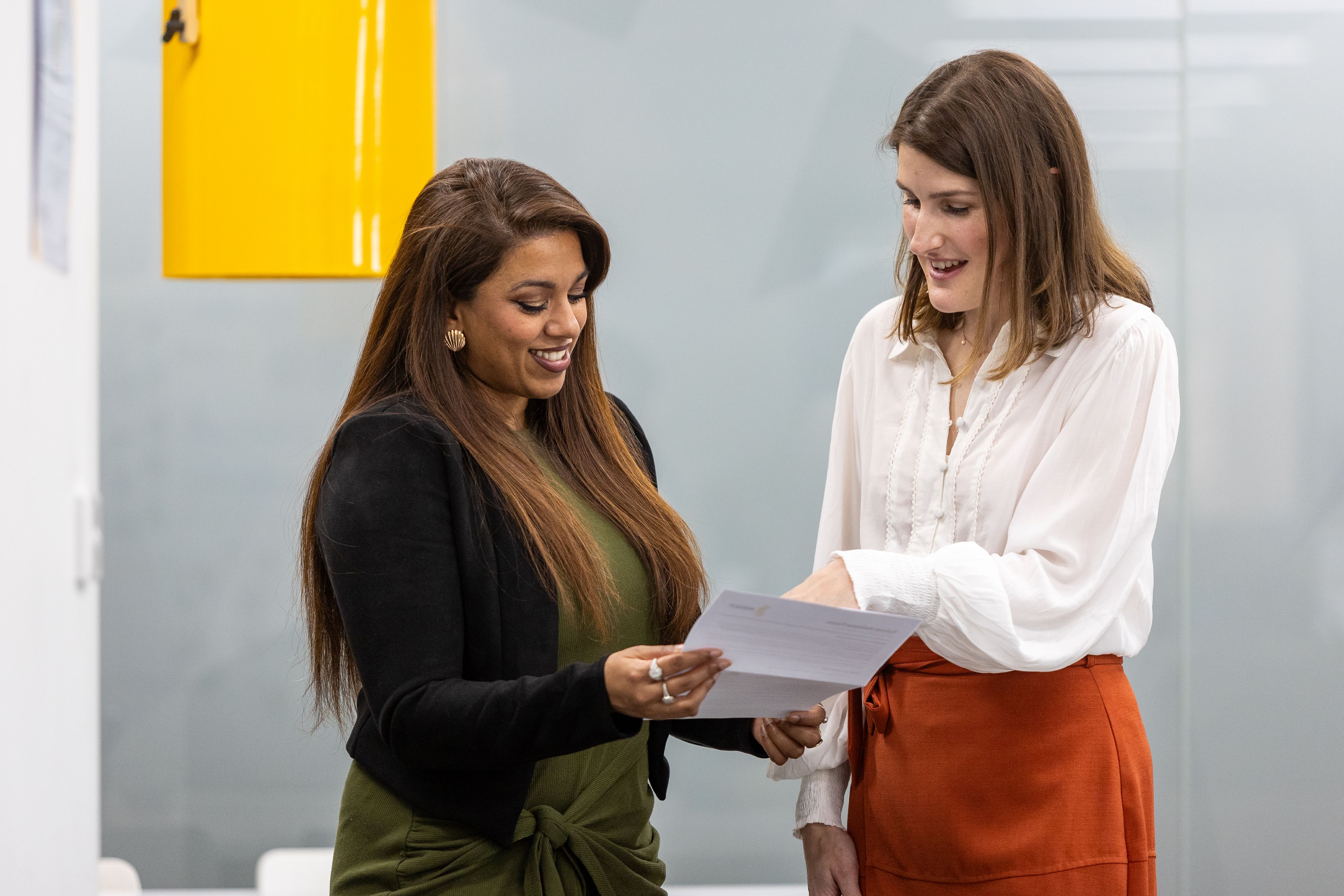 Two women discussing the contents of a document